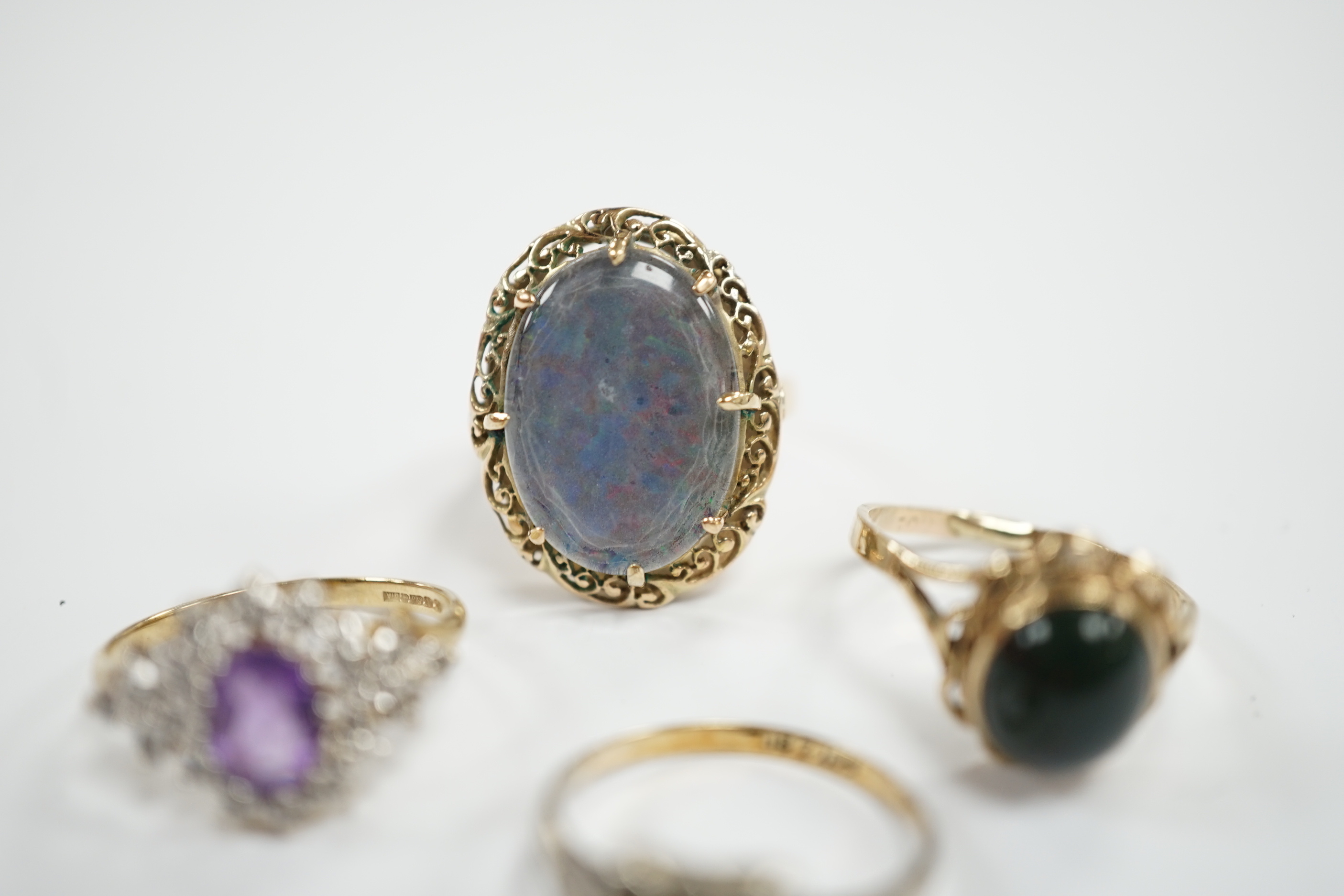 Two 9ct and gem set rings including cabochon bloodstone, a 14k and opal? doublet set ring and one other ring.